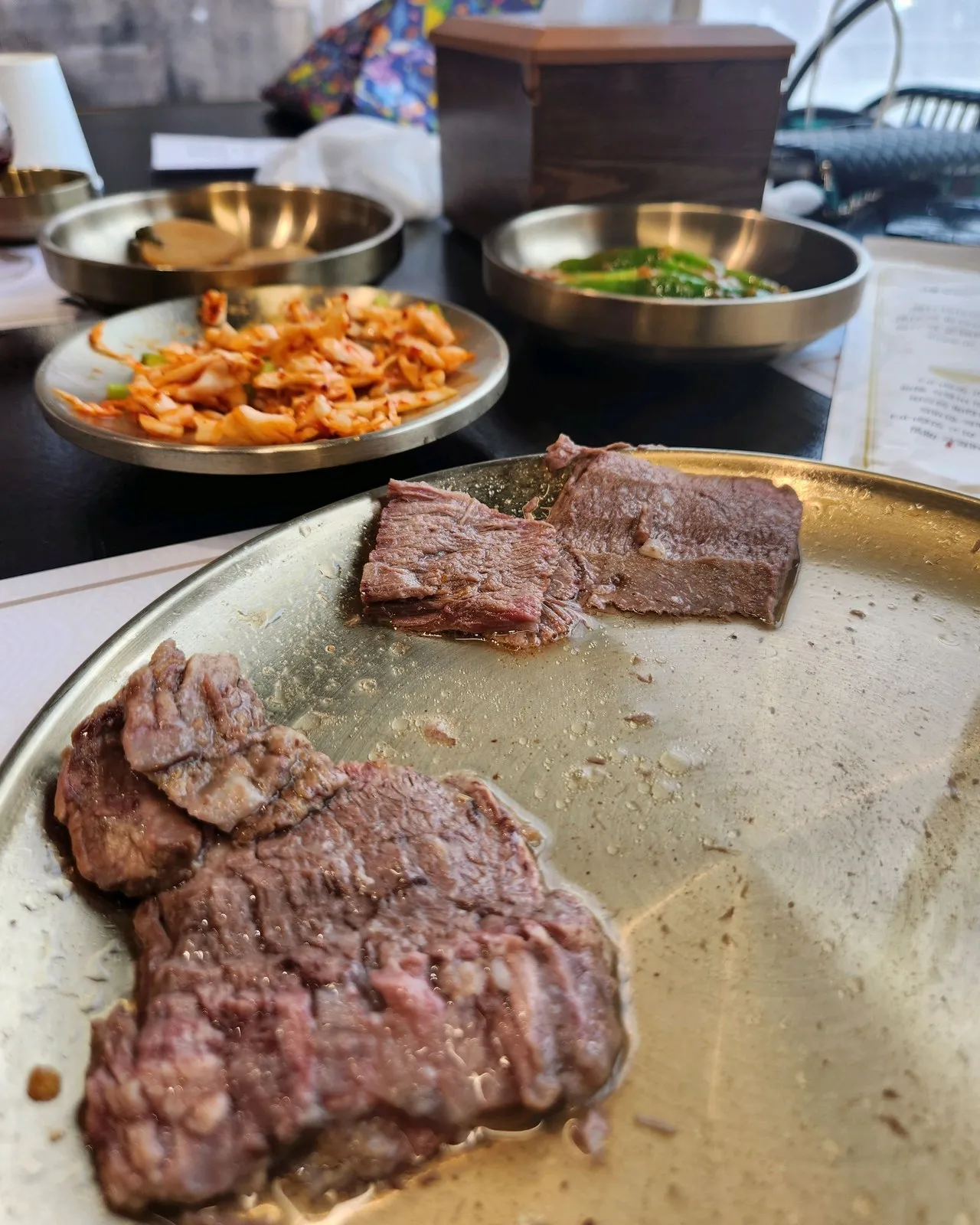 보쌈 고기 — 부드럽고 육즙이 가득합니다. 옆에 김치와 고추를 같이 냅니다
