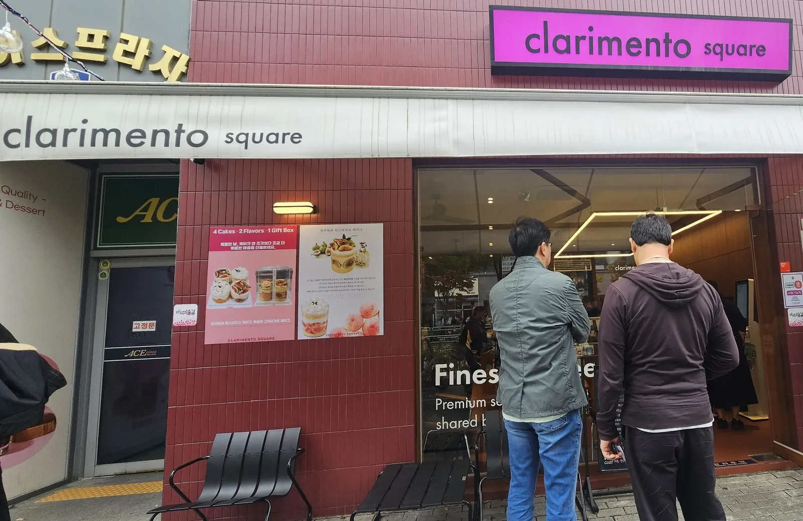 Outside the shop — the cake poster and chairs out front