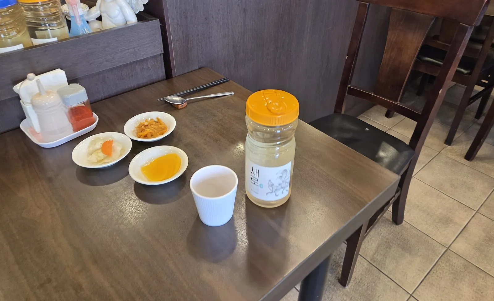 Three side dishes and a water bottle at my seat