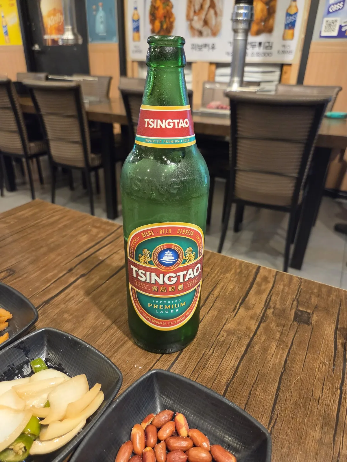 Tsingtao and side dishes of onion, chili pepper and peanuts