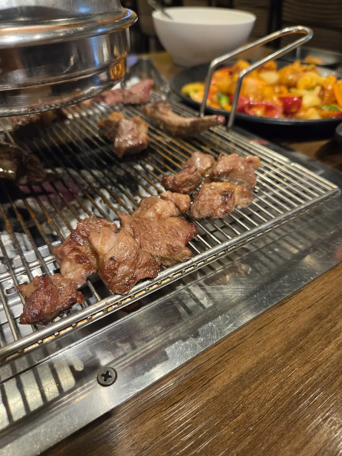 Lamb cooking on the charcoal grate