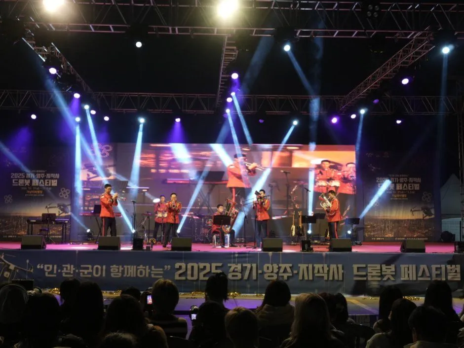 2025년 축제 — 조명 아래 무대에서 공연하는 음악 연주자들