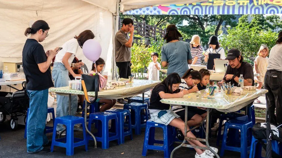 往屆慶典的體驗帳篷 — 坐在桌前畫畫、做手作的孩子們（照片：韓國觀光公社・公共授權第3類）